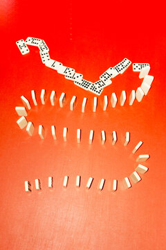 Domino game row on office business desk with hard direct flashlight 