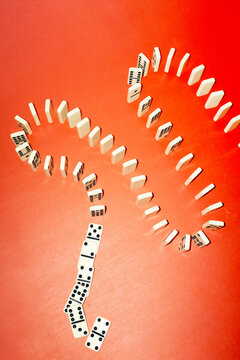 Domino game row on office business desk with hard direct flashlight 