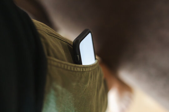 Phone screen glowing from pocket