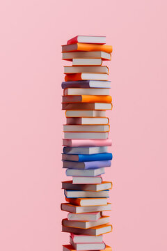 Colorful book tower on pink background