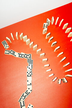 Domino game row on office business desk with hard direct flashlight 