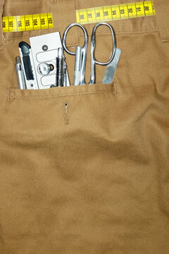 Trousers, measurement scale tape and silver metal tools in the pocket