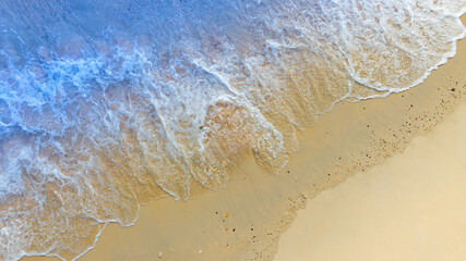 Top view beach sand background for summer vacation concept. Beach nature and summer seawater with sunlight light sandy beach Sparkling sea water	