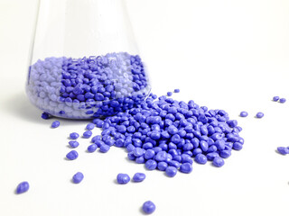 Blue masterbatch granules in Erlenmeyer flask and isolated on white background.Color pigment...