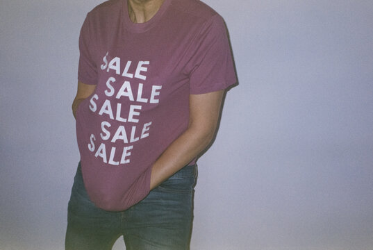 man wearing a T-shirt with the word sale, 35mm