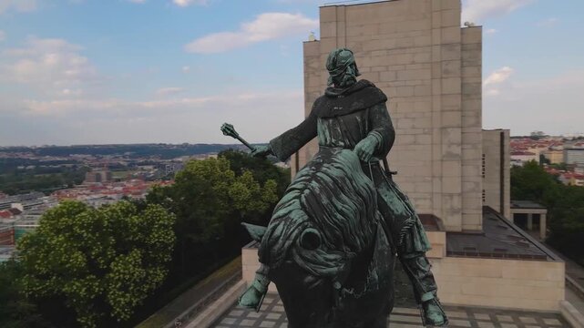 Aerial drone footage capturing the iconic Statue of Jan Žižka at V&iacute;tkov National Monument in Prague. The statue commemorates the legendary Czech general overlooking the city's landscape.