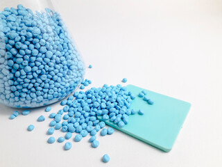 Electric blue masterbatch granules in erlenmeyer flask isolated on white background.Color pigment...