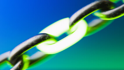 Close-up of Metal Chain with One Glowing Green Link