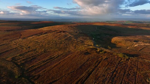 Bragan, County Monaghan, Ireland, September 2022. Drone tracks across wild rugged bog land parallel with the Irish border with Northern Ireland at golden hour.