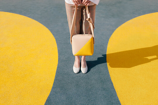 Fototapeta Stylish Woman with Handbag on Colorful Geometric Background