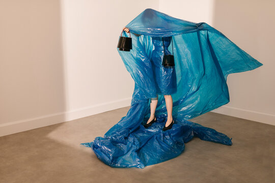 Abstract Art Installation With Blue Plastic And Black Buckets