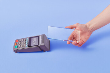 Man using transparent mobile for cashless payment on terminal
