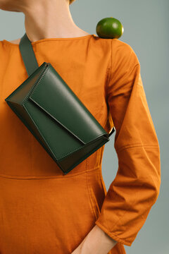 Modern Fashion with Green Bag and Orange Dress