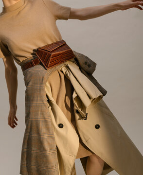 Fashion Model Posing in Stylish Beige Outfit with Accessories