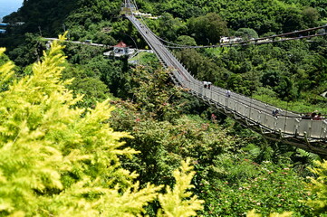 Taiwan - Jul 07, 2024: Enjoy the tranquility and stunning views of Taiping Suspension Bridge in Chiayi on a clear summer day, with the thrill of the swaying bridge and panoramic scenery.