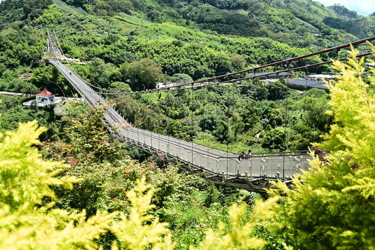 Taiwan - Jul 07, 2024: Enjoy the tranquility and stunning views of Taiping Suspension Bridge in Chiayi on a clear summer day, with the thrill of the swaying bridge and panoramic scenery.