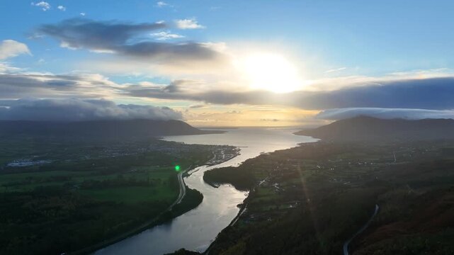 Flagstaff, County Down, Northern Ireland, November 2022. Drone pulls north above the Newry river with Warrenpoint and Carlingford Lough in the distance during the sunrise golden hour.