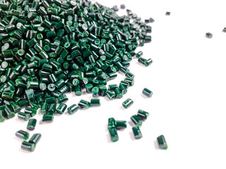 Forest green masterbatch granules on a white background. Color pigment carrier polymer in the...