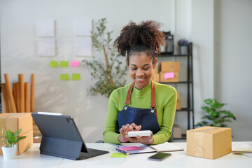 Young entrepreneur smiling and calculating finance of her business at home office