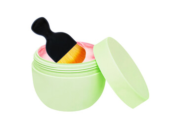 Closeup of an open cosmetic jar of concealer cream, makeup foundation, moisturising cream for the face and a brush. Clipping path. Beauty or make-up product.