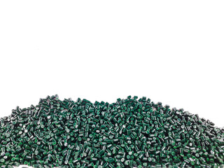 Forest green masterbatch granules on a white background. Color pigment carrier polymer in the...