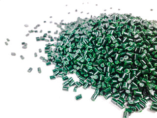 Forest green masterbatch granules on a white background. Color pigment carrier polymer in the...