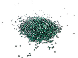 Forest green masterbatch granules on a white background. Color pigment carrier polymer in the...