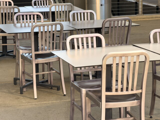 Outdoor stainless steel dining tables and chairs, closeup.