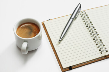 Notebook with pen and coffee