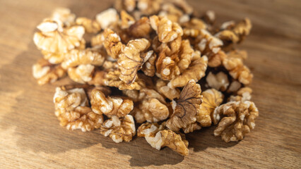 Peeled walnut kernels close-up on wooden background, Selective focus, tinted image.