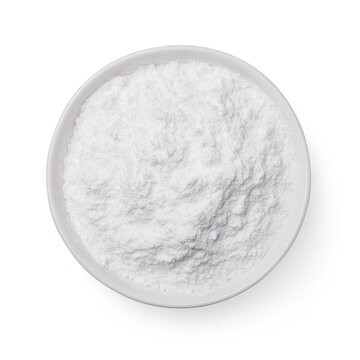 Full plate of powdered sugar isolated on white background, top view