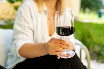 Close-up of a woman raising a glass of red wine