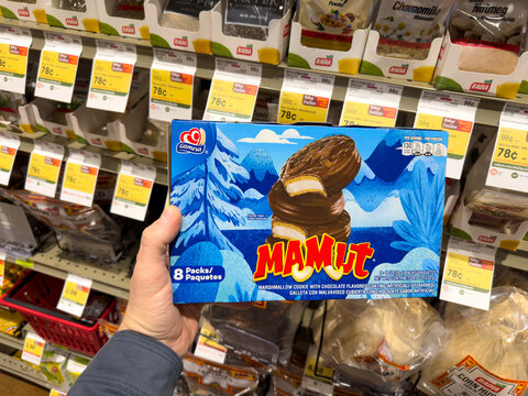 Holding a pack of Mamut chocolate cookies by the Gamesa company. 