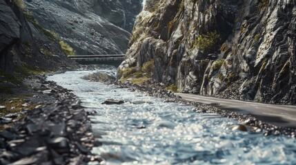 A serene mountain stream with flowing water, surrounded by rocky terrain and flanked by a hiking trail.