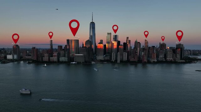 Aerial of Manhattan, New York City skyline at sunset. GPS location pins hover above iconic skyscrapers. Hudson River in foreground. Aerial at dusk.