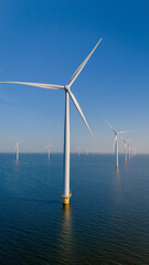 Breezy Turbines Dancing Over Tranquil Waters of a Dutch Windmill Park