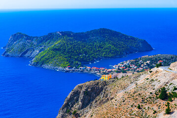 Assos, Kefalonia, Greece. Overview of the turquoise colored bay and Colorful city on an idyllic Ionian island