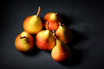 pears on a black background