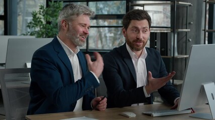 Two Caucasian men businessmen business partners colleagues corporate employees looking computer screen discussing online marketing financial project presentation in office talk planning work process - Powered by Adobe