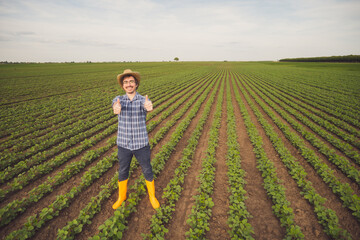 Portrait of happy farmer who is cultivating soybean.