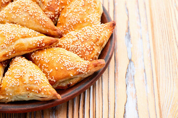 Homemade triangle puff pastry with meat on rustic background . Samosa