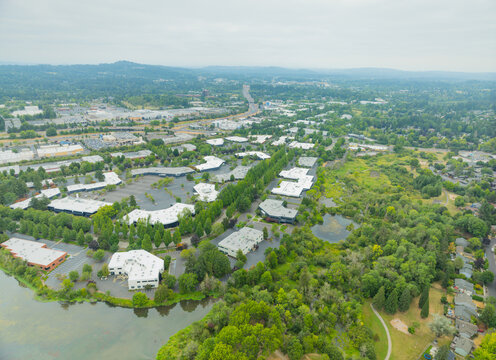 A city with a lot of buildings and a lake in the background