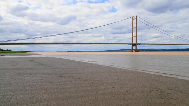 Aerial drone view of Humber Bridge, 12th largest suspension span, gracefully crossing River Humber, connecting Lincolnshire to Humberside with traffic.
