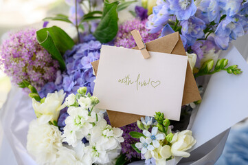 Composition with an empty envelope and beautiful flowers on the background. Postcard layout...