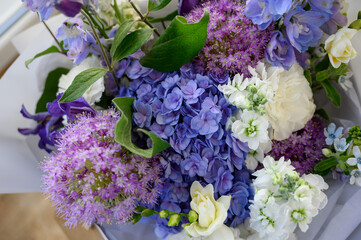 A beautiful bouquet of mixed flowers from hydrangea. The concept of a flower shop. A beautiful freshly cut bouquet. Delivery of flowers