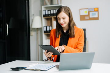 Business woman sitting at a desk using a laptop computer Navigating Finance and Marketing with Technology