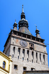 The The Clock Tower or the Council Tower of the medieval citadel in the old center of Sighisoara, a UNESCO World Heritage Site in Transylvania (Transilvania) region, Romania, in a sunny summer day.