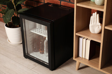 Modern mini refrigerator with drinks at home