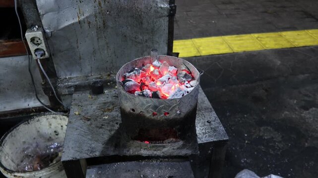 Jakarta, Indonesia - August 03, 2024: Hot coals from charcoal for cooking Javanese noodles.