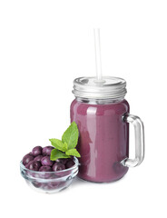 Tasty acai juice in mason jar, mint and berries isolated on white